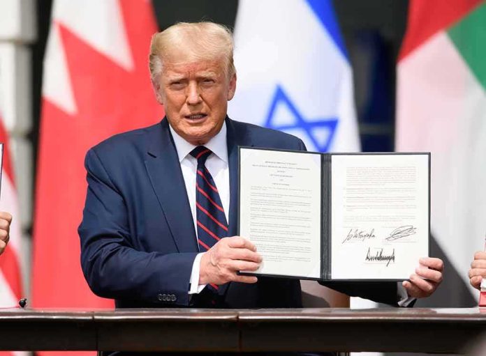 shutterstock_1816392461 Donald Trump holding a signed document at a ceremony
