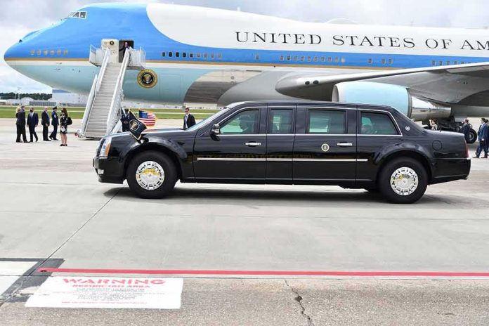 shutterstock_1822049969 Presidential motorcade limousine parked beside large blue and white aircraft