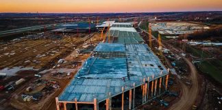 aerial view of large industrial building under construction at sunset
