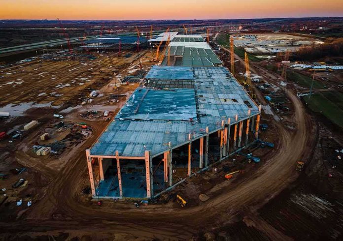 aerial view of large industrial building under construction at sunset