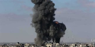 Drone Swarm Slams Russian Oil Hub Thick black smoke rises from an explosion over a dense urban area
