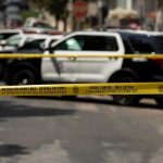 News Chopper Plunges – L.A. Stunned Police tape cordoning off street with patrol SUVs behind
