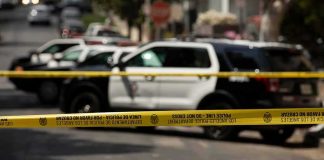 News Chopper Plunges – L.A. Stunned Police tape cordoning off street with patrol SUVs behind