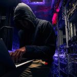 AI Dragnet Targets Pentagon Choke Points Hooded person using a laptop in a dark server room