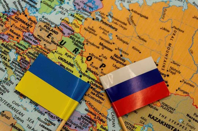 Ukraine and Russia flags on a map of Eastern Europe