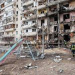 Kyiv Ablaze After Drone Barrage Damaged apartment building behind a playground slide