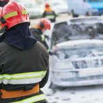 Firefighter Arson Bombshell Firefighter near foam-covered car with open hood