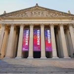 Neoclassical museum facade with tall columns and wide stone steps