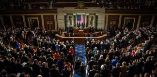 Legislative chamber audience stands and applauds