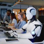 Job Apocalypse? Vance Says Not So Fast Robot and office workers at computers in a modern workspace