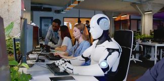 Job Apocalypse? Vance Says Not So Fast Robot and office workers at computers in a modern workspace