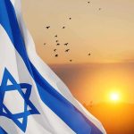 Israeli flag waving at sunset with birds in the sky