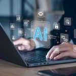 AI Builders Predict Doomsday – This Decade Hands typing on laptop with AI and tech icons overlay