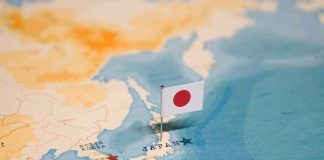 Japanese flag pin marking Japan on a world map