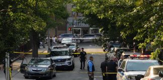 Hollywood Heir, No Death Bid Police officers secure a residential street with patrol cars and yellow tape