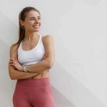 WNBA Star Torches Sydney Sweeney Spot Woman in athletic wear smiling with arms crossed