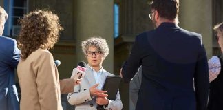 Spokesperson addresses reporters on courthouse steps