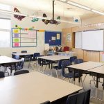 Fired Teacher Resurfaces In Elementary Classroom Empty classroom with tables, chairs, and a whiteboard