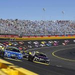 Racing Legend’s Brain Scare Stuns NASCAR Stock cars racing on a banked track with grandstands in background