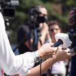Independence Mall Showdown Begins Reporters hold microphones during an outdoor press interview