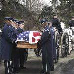 Boot Camp Outbreak Explodes, Mandates Roar Back Military honor guard carries a flag-draped casket beside a hearse and caisson