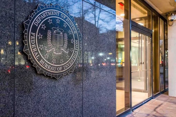 shutterstock_555190222-1 FBI emblem on a stone wall beside a glass entrance