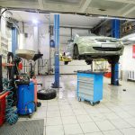 Unanswered Questions: NASCAR Champion’s Sudden Death Car on hydraulic lift in auto repair shop