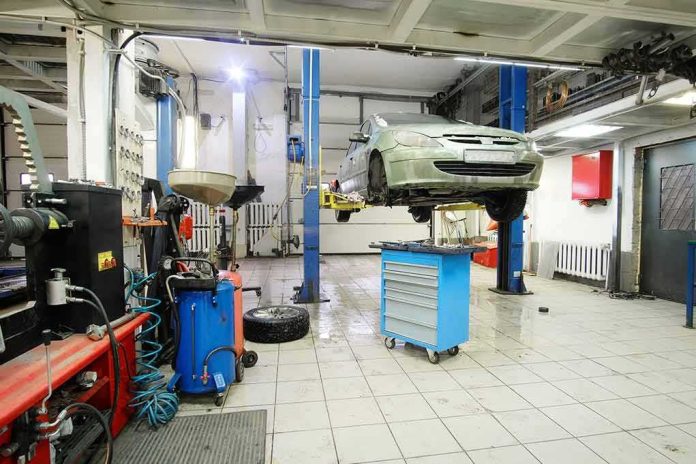Car on hydraulic lift in auto repair shop