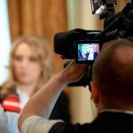 NBC Showdown Explodes — Trump Walks? tv camera films interview with blurred speaker