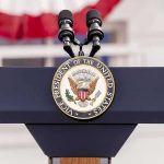 podium with microphones and U.S. vice presidential seal