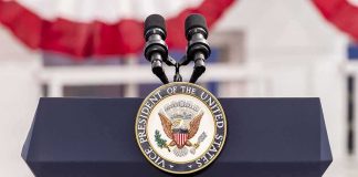 podium with microphones and U.S. vice presidential seal