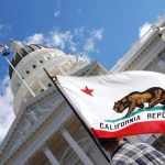 National Billionaire Tax: What’s The Catch? California state flag in front of a white domed capitol building