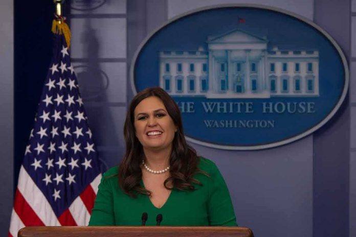woman speaking at a White House press briefing podium
