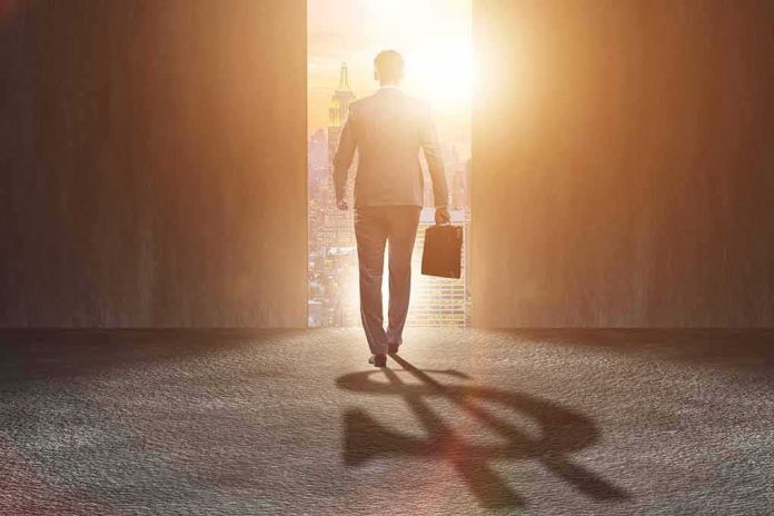 shutterstock_744434371 Businessman walking toward bright city doorway with briefcase