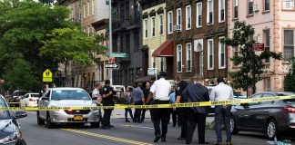 Bronx Chaos After ICE Opens Fire Police gathered at an urban crime scene.