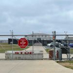 Fort Gordon Predator Arrest Shocks Military Ranks Chain-link fence with Restricted Area Stop No Photography sign.