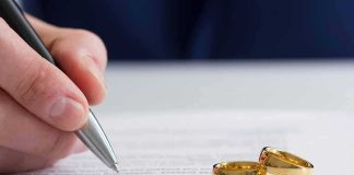 Germany’s Child Marriage Bombshell Hand signing a document beside two gold wedding rings