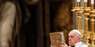 Emergency Op Looms For The Pope Catholic priest holds ornate book during ceremony