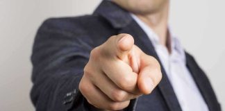 Ambassador Ousted Over $100K Ask? hand pointing directly at the camera