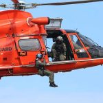Coast Guard Scrambles After Jet Disappears Rescue helicopter with crew performing hoist operation