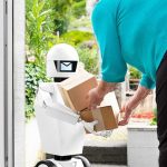 Delivery robot handing packages to a person at a doorstep