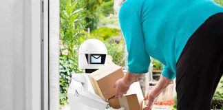 Delivery robot handing packages to a person at a doorstep