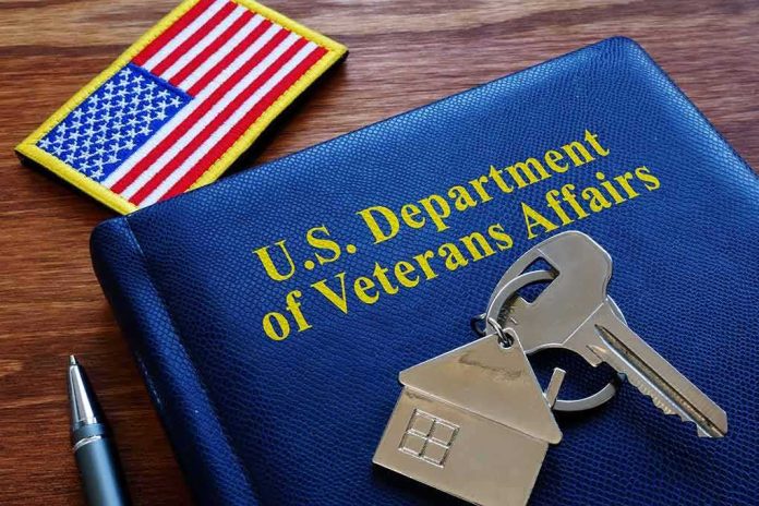 VA folder with house keychain and US flag patch on wooden desk