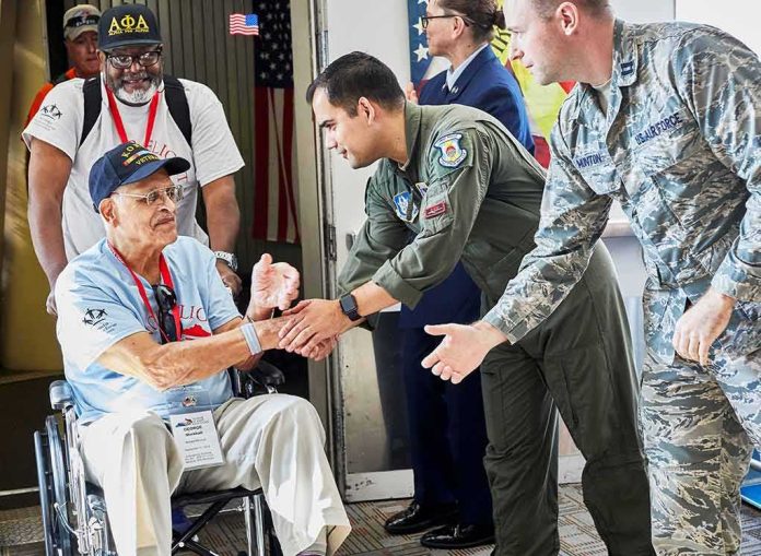 Veteran in wheelchair greeted by military personnel at event