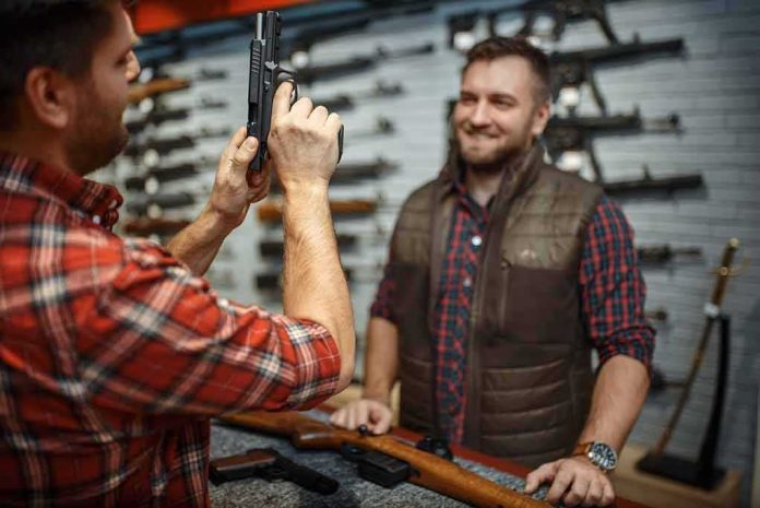 man examining a handgun at a gun store counter