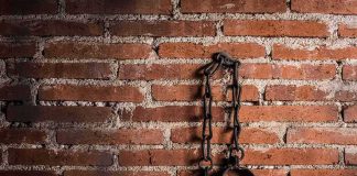 NY Lawyer Tortures Woman for 7 Hours Iron shackles hanging on a brick wall