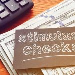 Obamacare Fees Boomerang – Cash Back? stimulus checks note on cash with calculator