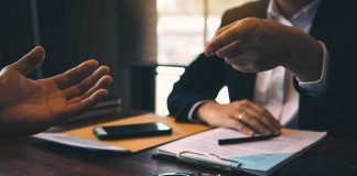 FBI Storms OpenAI Boardroom Two people in discussion at a desk with handcuffs and documents