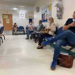 America’s Heart Care Bottleneck People wearing masks seated in a hospital waiting room