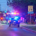 School Horror – Father Drops Gunman Emergency vehicles with flashing lights on a city street at night